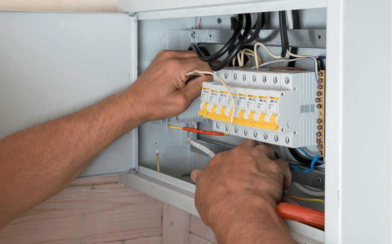 Technician installing circuit breakers in box